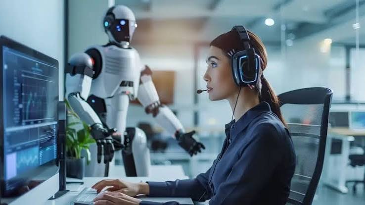 Customer service agent wearing a headset working alongside a humanoid AI robot in an office setting