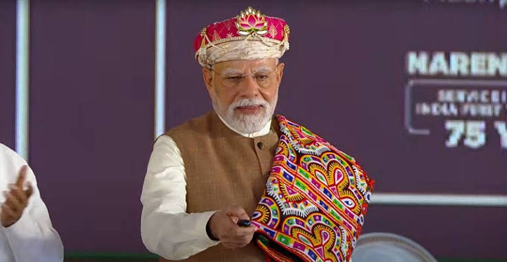 Prime Minister Narendra Modi being felicitated at a public event