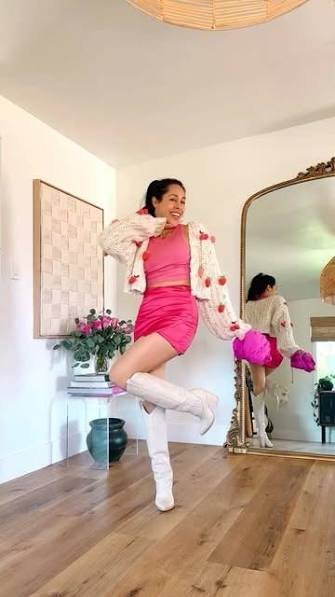 Fashion influencer posing in a pink outfit representing viral style and social media trends
